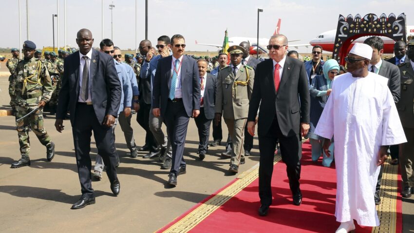 Turkish President Recep Tayyip Erdogan and Malis then-President Ibrahim Boubacar Keita walk at the airport in Bamako